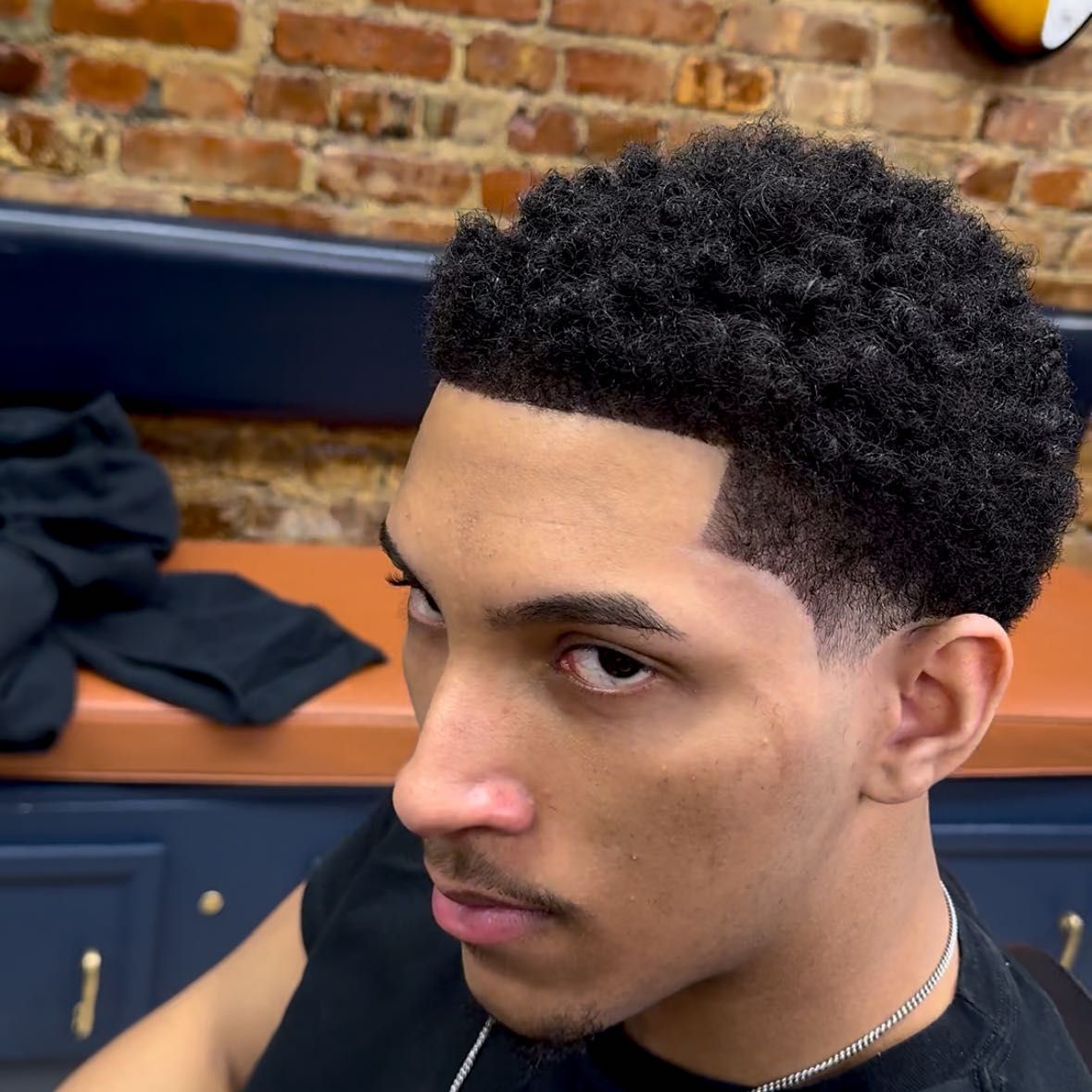 Barber at work inside Shmoneycuts, Washington Heights NYC